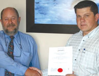 Pierre Enslin, BM Trada (left) hands the ISO certificate to Albert Bower, managing director of Becker Electronics